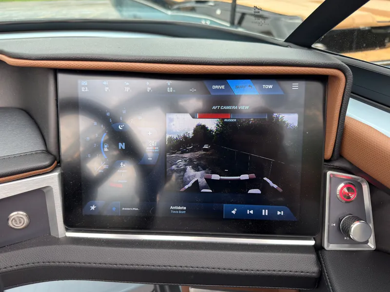 Slide: The Image of The image shows the dashboard of a MasterCraft XT20 with a modern touchscreen display. - 49