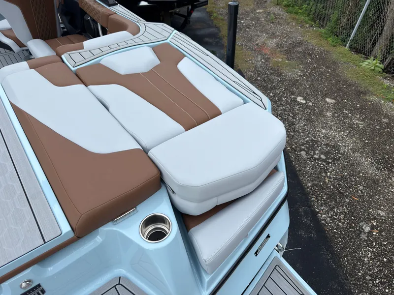 Slide: The Image of The image shows the stern of a 2027 MasterCraft XT20 with brown and white upholstery. - 11