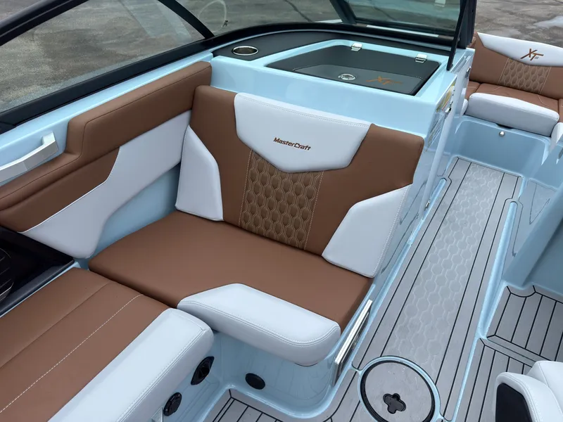 Slide: The Image of The 2027 MasterCraft XT20 features stylish interior with brown and white upholstery. - 28