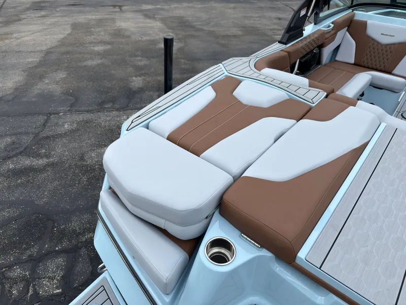 Slide: The Image of The image shows the rear of a 2027 MasterCraft XT20 with brown and white upholstery. - 9