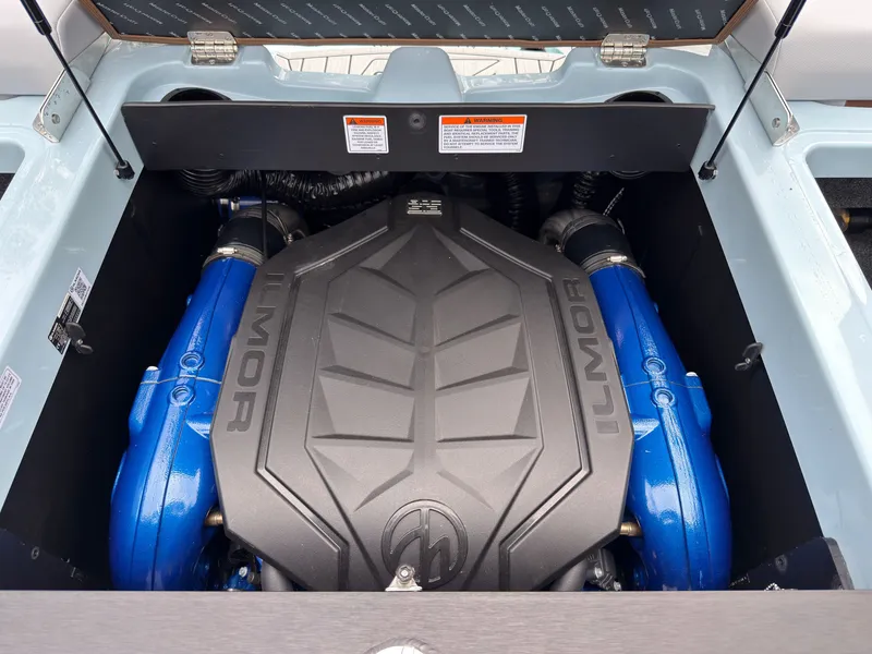Slide: The Image of The engine compartment of a 2027 MasterCraft XT20 features a powerful Ilmor engine with blue covers. - 21