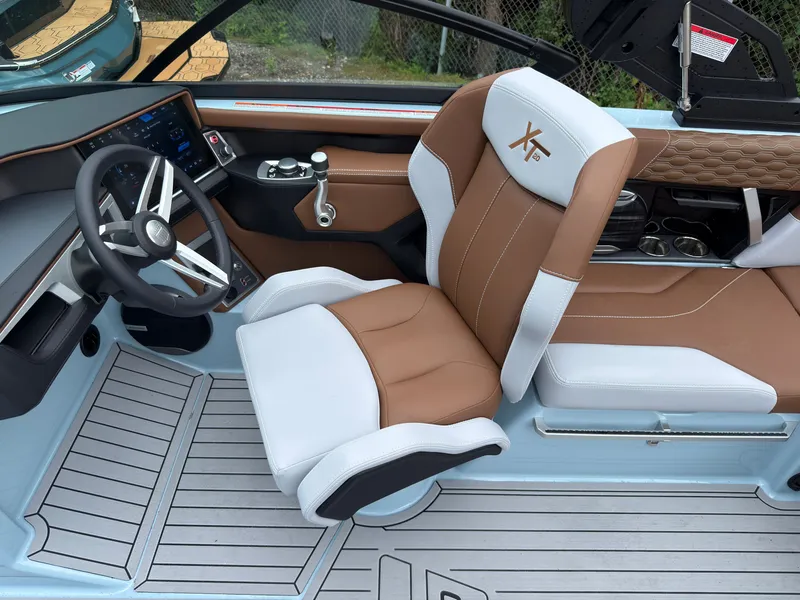 Slide: The Image of The image shows the interior of a 2027 MasterCraft XT20 with a modern steering wheel and cushioned seat. - 33