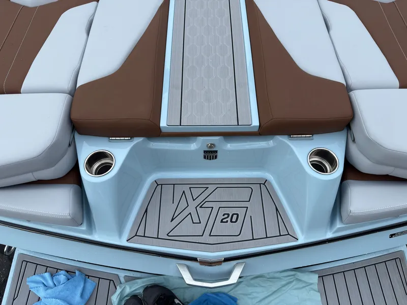 Slide: The Image of The image shows the stern of a MasterCraft XT20 boat with brown and gray upholstery. - 8
