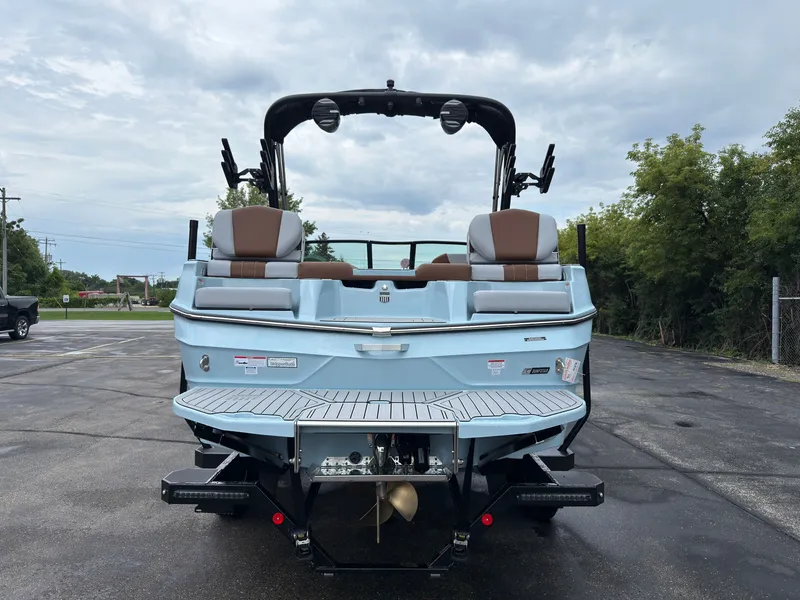 Slide: The Image of The image shows a 2027 MasterCraft XT20 boat with a blue exterior and brown seating. - 6