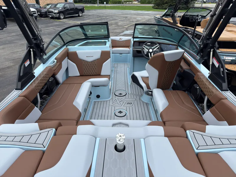 Slide: The Image of The image shows the interior of a 2027 MasterCraft XT20 with brown and gray seating. - 15