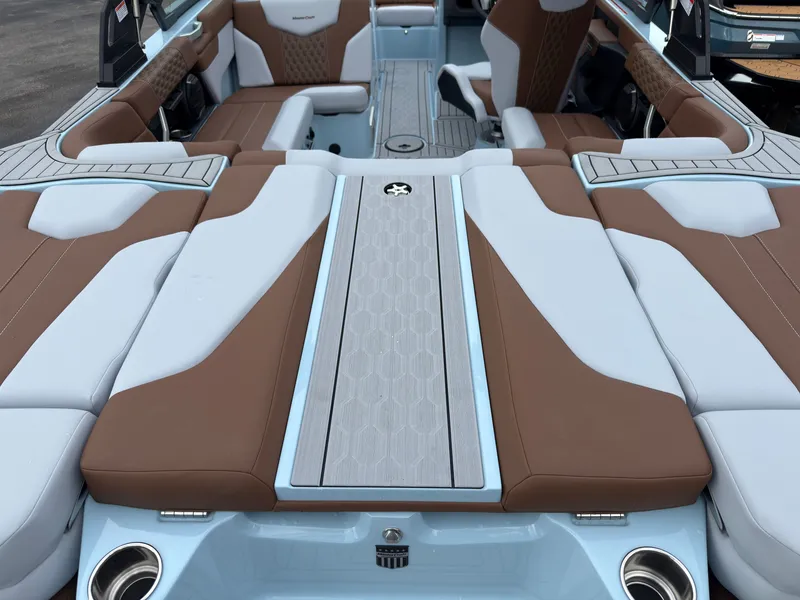 Slide: The Image of The image shows the luxurious interior of a 2027 MasterCraft XT20 with brown and gray upholstery. - 10