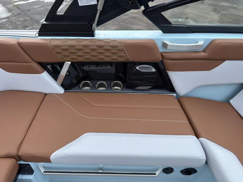 Slide: The Image of The 2027 MasterCraft XT20 features stylish interior with brown and white upholstery. - 26