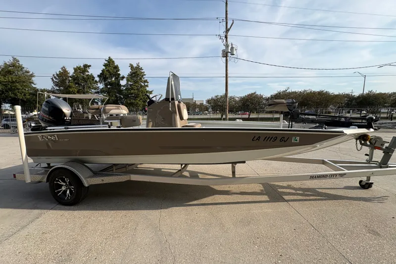 Slide: The Image of 2019 Excel 203 Bay Pro boat on trailer, parked outdoors under clear sky. - 4