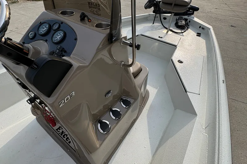 Slide: The Image of 2019 Excel 203 Bay Pro boat interior with steering console and seating. - 19