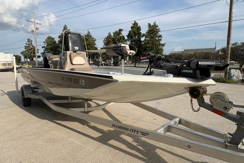 Slide: The Image of 2019 Excel 203 Bay Pro boat on trailer, featuring Lowrance equipment, parked outdoors. - 3
