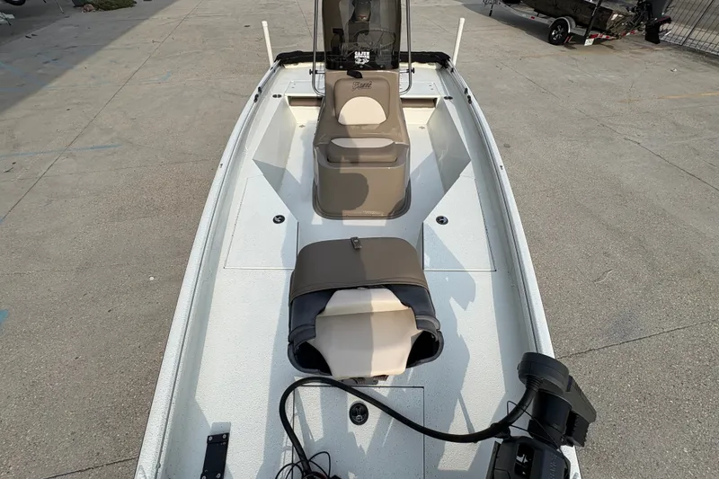 Slide: The Image of 2019 Excel 203 Bay Pro boat with seating and equipment on a concrete surface. - 13