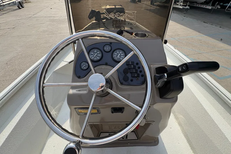 Slide: The Image of 2019 Excel 203 Bay Pro boat dashboard with steering wheel and control panel. - 11