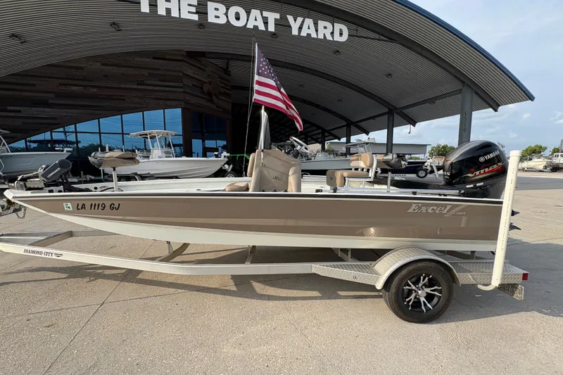 Slide: The Image of 2019 Excel 203 Bay Pro boat on trailer at dealership, featuring Yamaha outboard motor. - 9