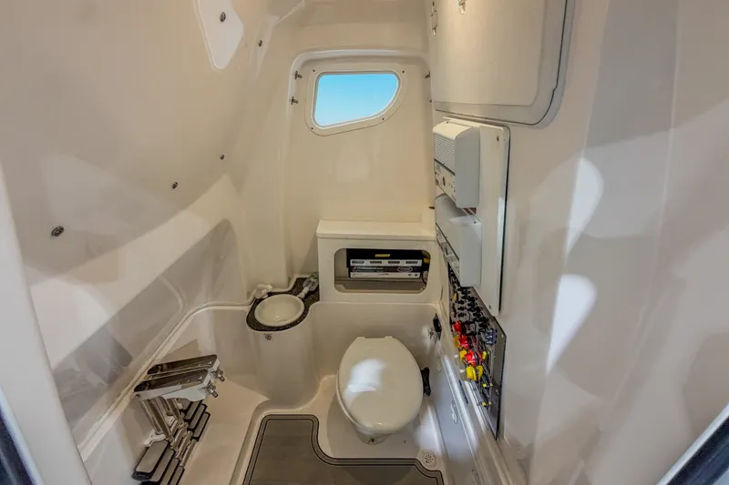 Slide: The Image of Interior of 2022 Sea Fox 288 Commander boat bathroom with toilet and control panel. - 16