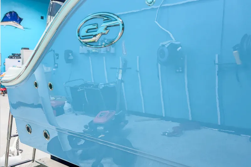 Slide: The Image of 2022 Sea Fox 288 Commander boat hull in a showroom, showcasing sleek design and logo. - 8