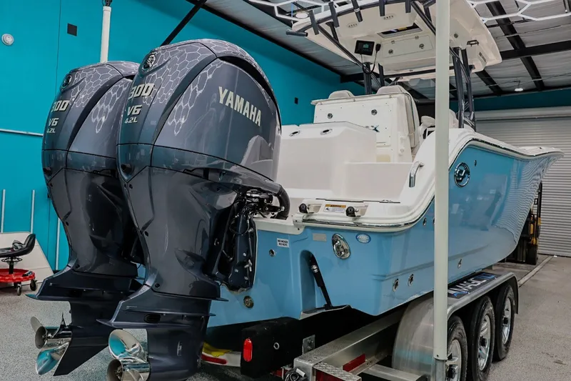 Slide: The Image of 2022 Sea Fox 288 Commander with twin Yamaha engines in a garage setting. - 5