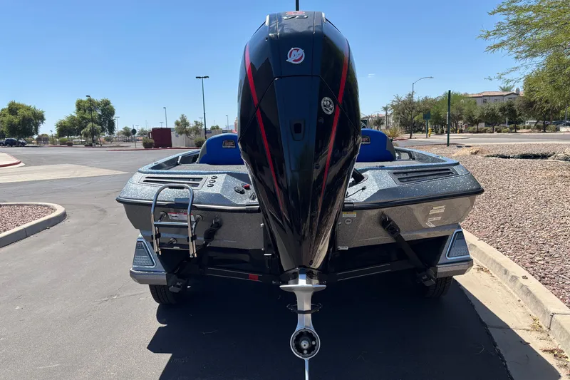 Slide: The Image of 2027 Ranger Z518 Cup-Equipped boat with powerful outboard motor, parked on sunny street. - 4