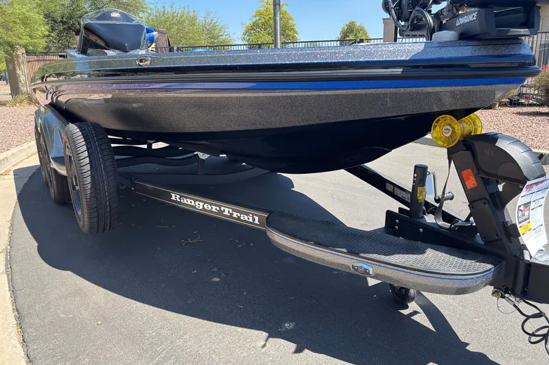 Slide: The Image of 2027 Ranger Z518 Cup-Equipped boat on trailer, parked outdoors, showcasing sleek design. - 6