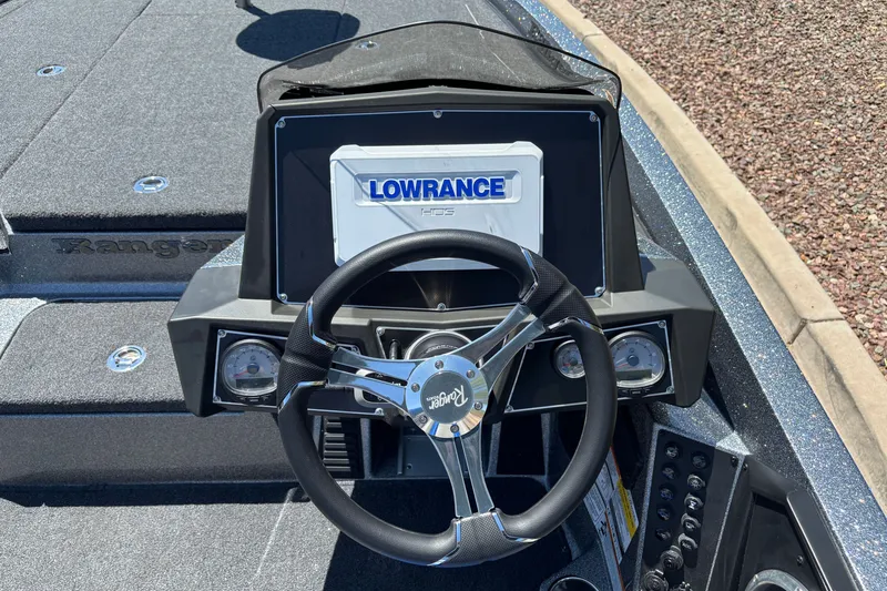 Slide: The Image of 2027 Ranger Z518 Cup-Equipped boat dashboard with Lowrance HDS display and steering wheel. - 9