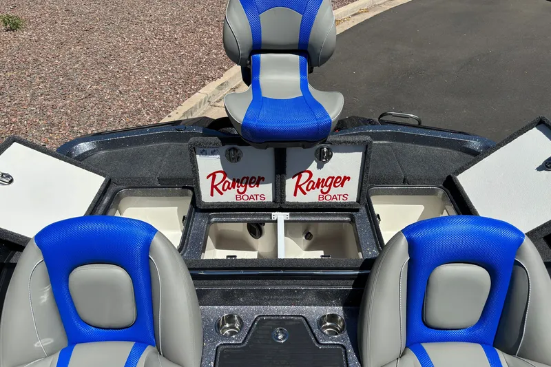 Slide: The Image of 2027 Ranger Z518 Cup-Equipped boat interior with blue and gray seating. - 18