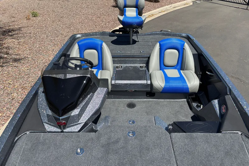 Slide: The Image of 2027 Ranger Z518 Cup-Equipped boat interior with blue and gray seating. - 16
