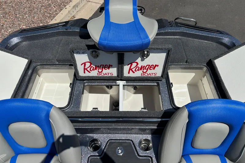 Slide: The Image of 2027 Ranger Z518 Cup-Equipped boat interior with blue seats and storage compartments. - 19