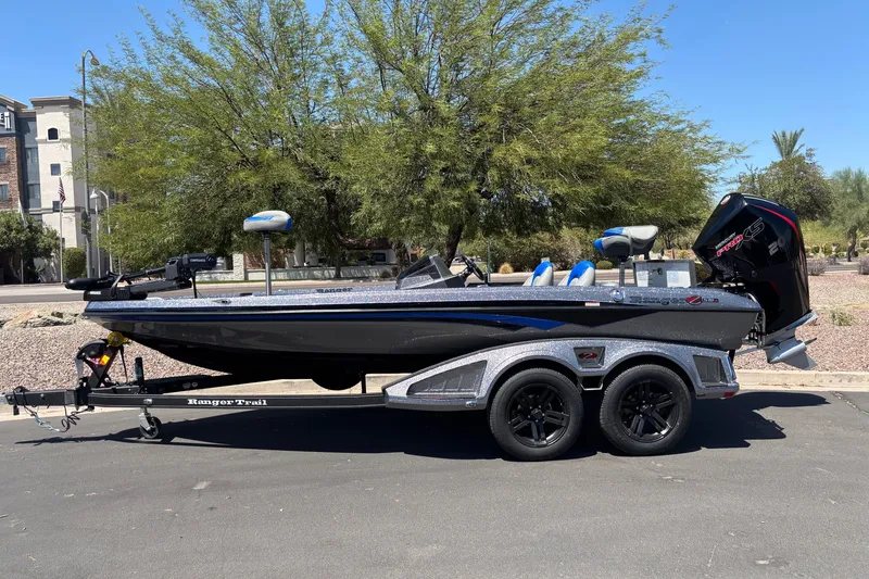 The Image of 2027 Ranger Z518 Cup-Equipped boat on trailer, parked outdoors, side view. - 0