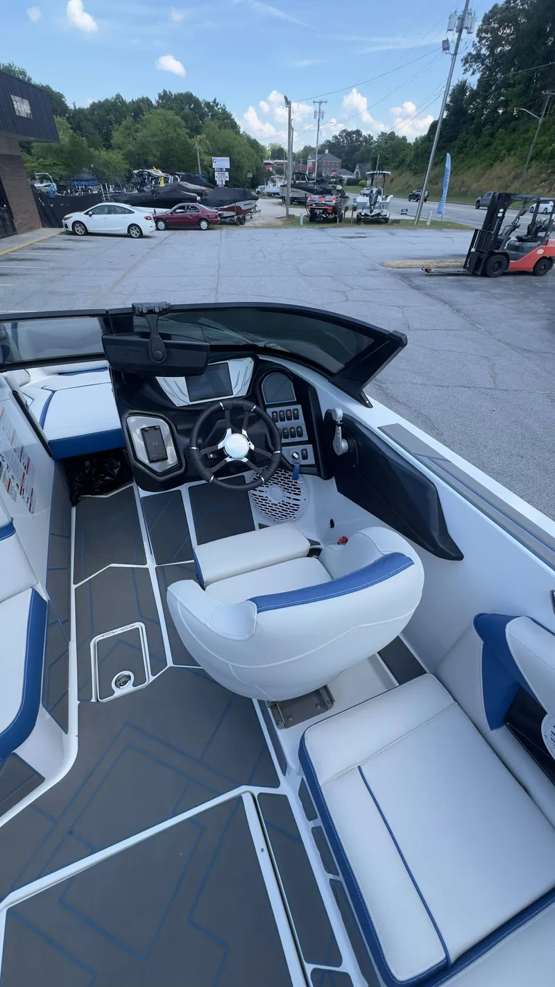 Slide: The Image of The image shows the cockpit of a 2022 Supreme S220 boat with modern seating and controls. - 7