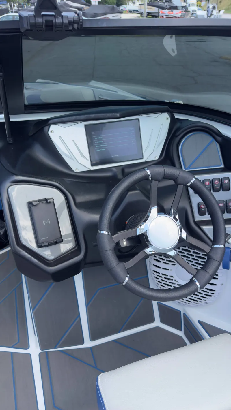Slide: The Image of The image shows the cockpit of a 2022 Supreme S220 boat with a modern steering wheel and screen. - 8