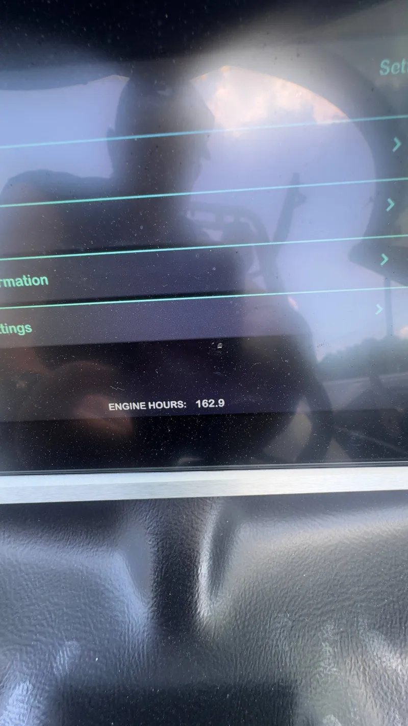 Slide: The Image of A screen displays 162.9 engine hours. Reflections are visible. - 11