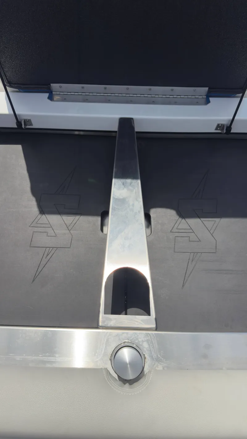 Slide: The Image of Close-up of a boat detail with a metal handle and embossed logo on a black background. - 16