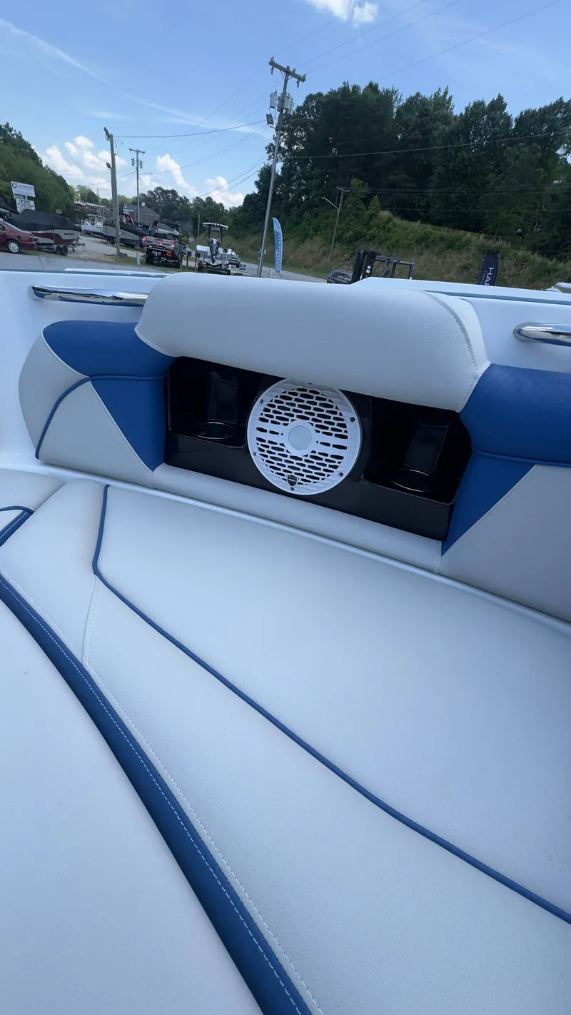 Slide: The Image of The image shows the interior of a 2022 Supreme S220 boat with blue and white seating. - 14