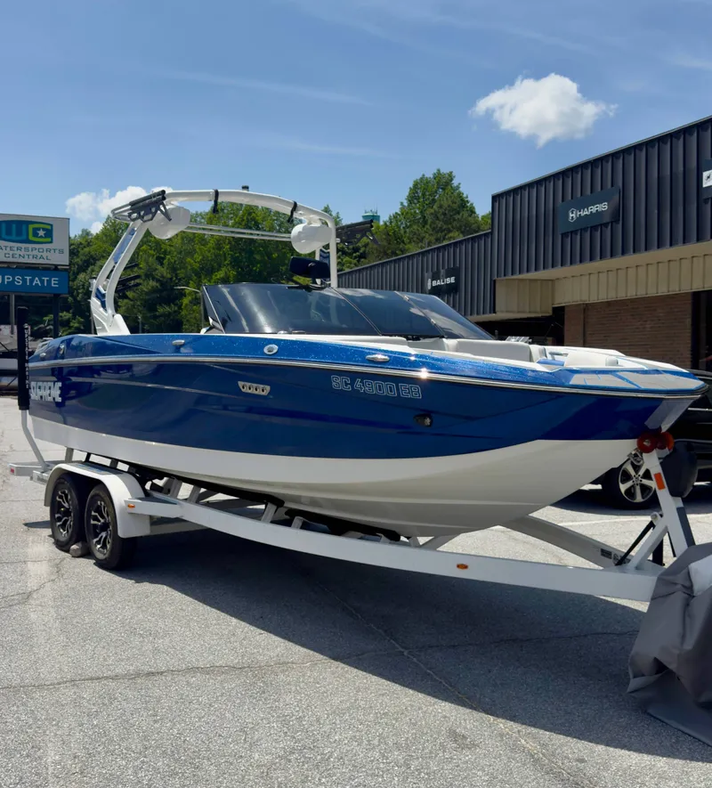 Slide: The Image of A blue 2022 Supreme S220 on a trailer in front of a building. - 3