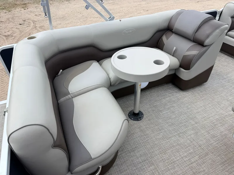 Slide: The Image of Interior of a Premier 220 SunSpree with beige and brown seating and a round table. - 9
