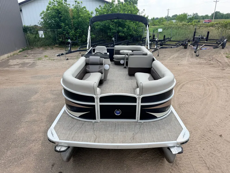 Slide: The Image of A 2016 Premier 220 SunSpree pontoon boat with gray seating and a black Bimini top. - 10