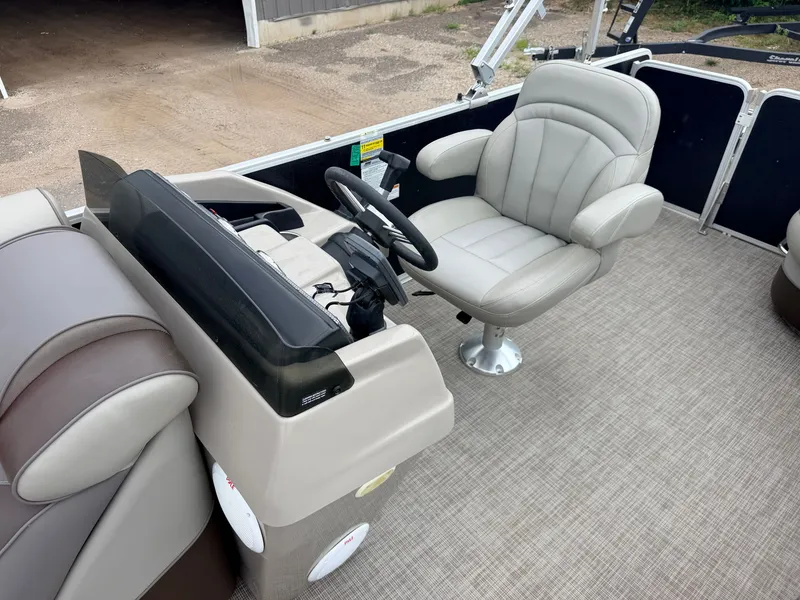 Slide: The Image of The image shows the cockpit of a 2016 Premier 220 SunSpree with a comfortable captain's chair. - 19