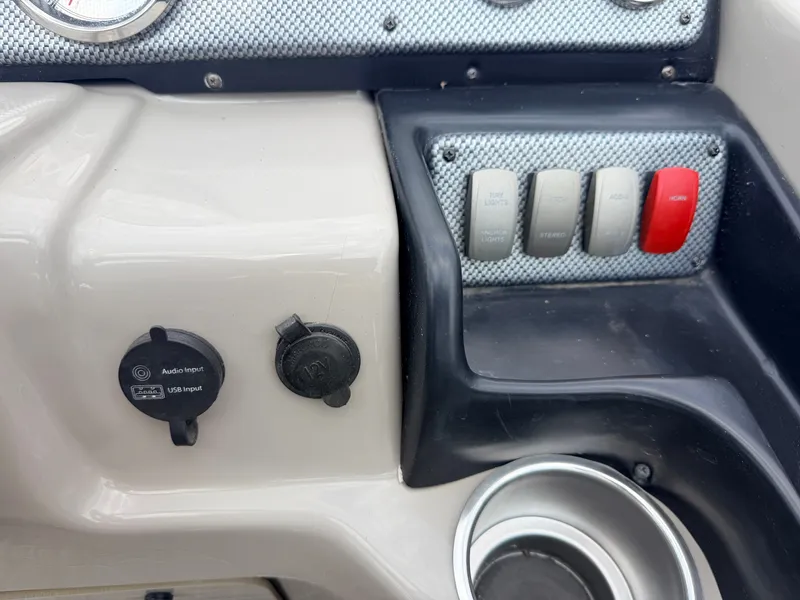 Slide: The Image of The image shows the dashboard of a Premier 220 SunSpree boat with USB and audio inputs. - 26