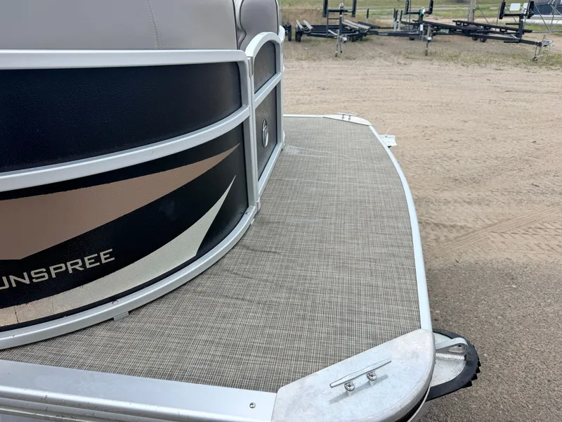 Slide: The Image of Close-up of the deck of a Premier 220 SunSpree pontoon boat on a trailer. - 11