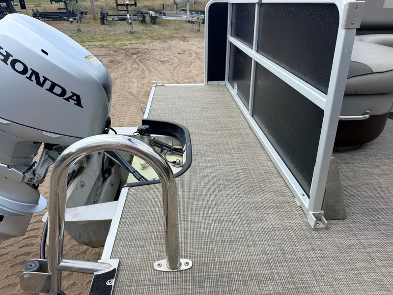 Slide: The Image of A 2016 Premier 220 SunSpree with a 50HP Honda 4-stroke engine. The rear deck is visible. - 35