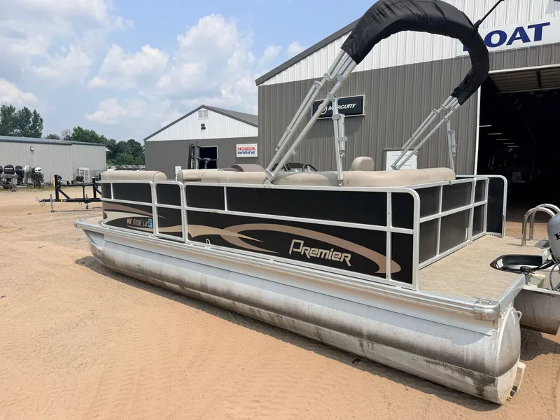 Slide: The Image of A 2016 Premier 220 SunSpree pontoon boat with a 50HP Honda 4-stroke engine, parked on sand. - 46