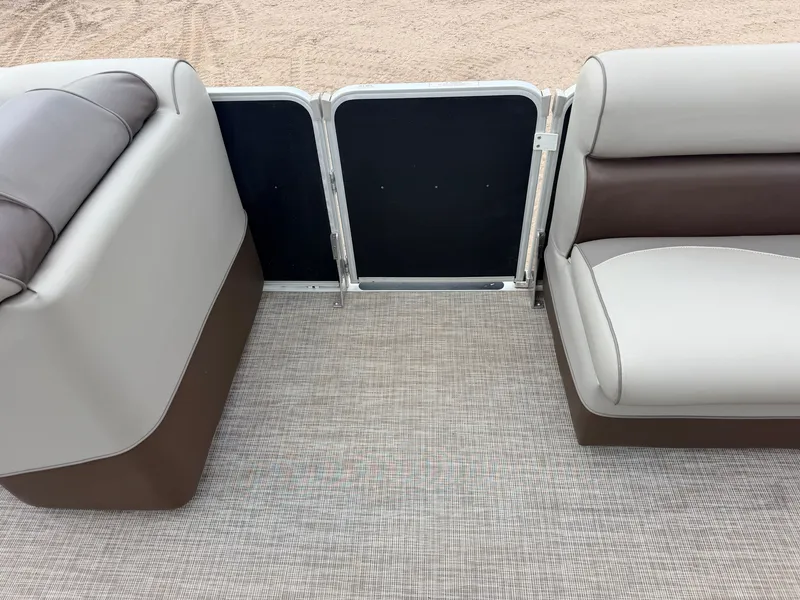 Slide: The Image of The image shows the seating area of a pontoon boat with beige and brown upholstery. - 14