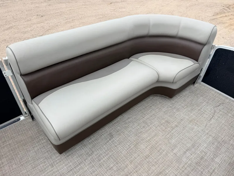 Slide: The Image of A sleek, curved seating sofa in cream and brown on a boat. - 13