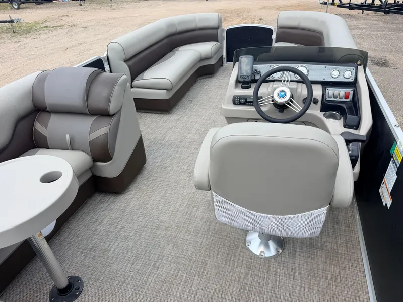 Slide: The Image of The image shows the interior of a 2016 Premier 220 SunSpree boat with gray upholstery and a modern helm. - 6