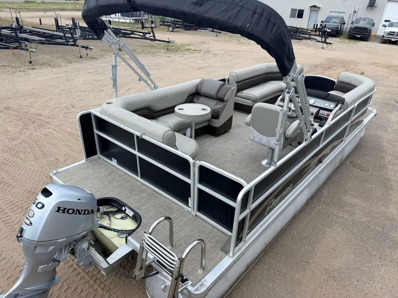 Slide: The Image of A 2016 Premier 220 SunSpree pontoon boat with a 50HP Honda 4-stroke engine, parked on dry ground. - 7