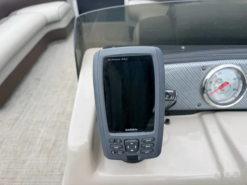 Slide: The Image of A Garmin fishfinder is mounted on the dashboard of a Premier 220 SunSpree boat. - 24