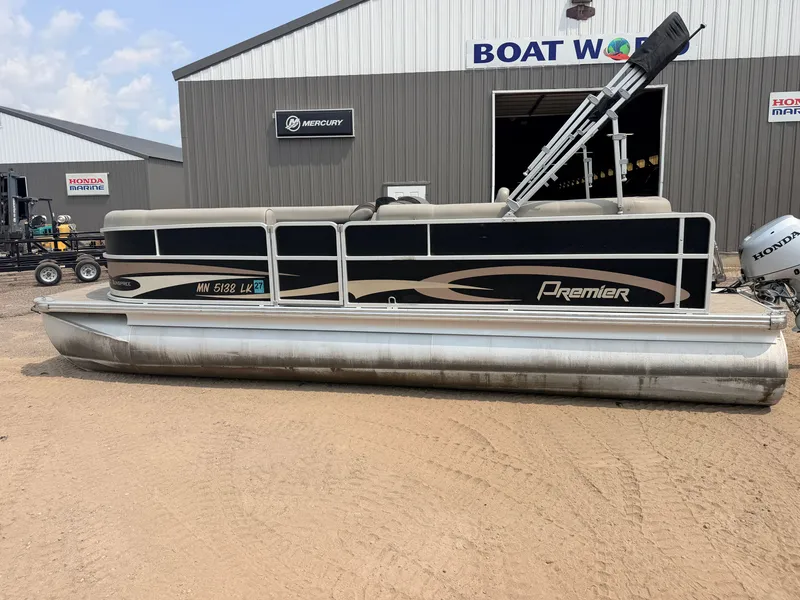 Slide: The Image of A 2016 Premier 220 SunSpree pontoon boat with a 50HP Honda 4-stroke engine, parked on sand. - 44