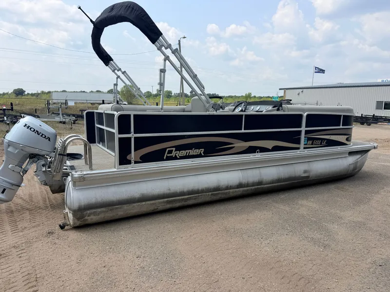 Slide: The Image of A Premier 220 SunSpree pontoon boat with a 50HP Honda 4-stroke engine, on sandy terrain. - 48