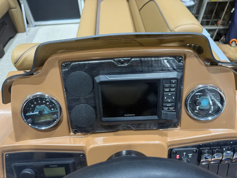 Slide: The Image of The image shows a boat dashboard with a Garmin navigation system and two round gauges. - 13