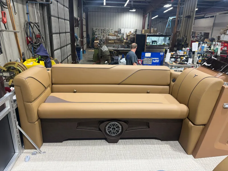 Slide: The Image of The image shows a beige bench seat in a boat, surrounded by a workshop setting. - 28