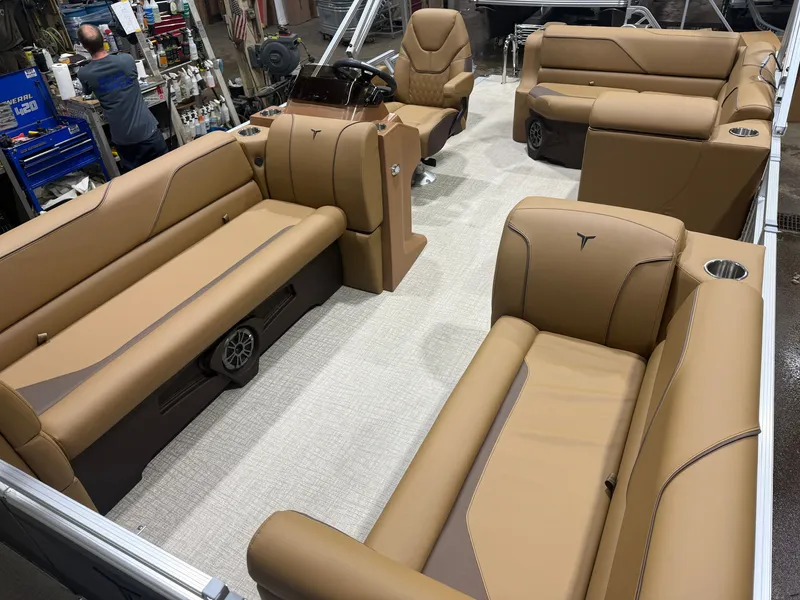 Slide: The Image of Interior of a modern pontoon boat with beige leather seating and a central helm station. - 26